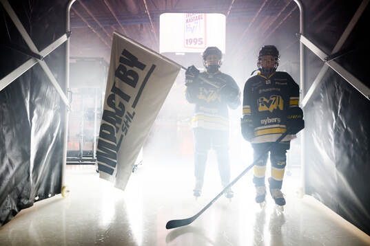 Två maskotar med en Impact by SHL