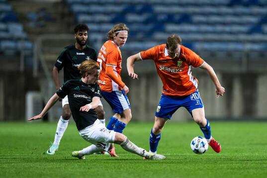 Elias Sandrød of Rosenborg competes for the ball with