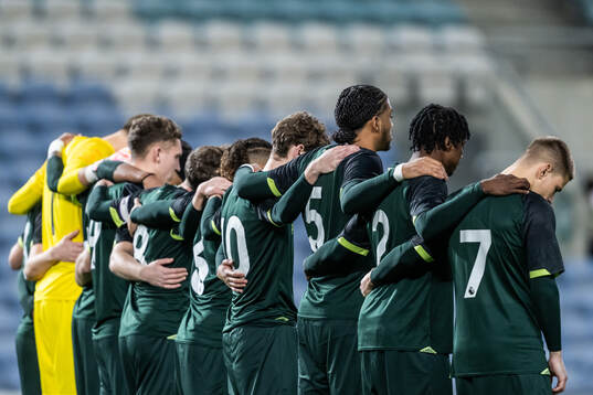 Players of Brentford B in a minute of silence to honor the