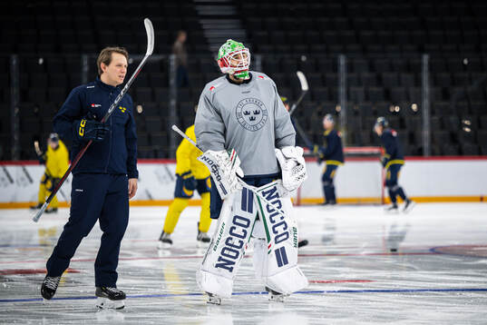 Goaltender coach Viktor Alm and goaltender Linus