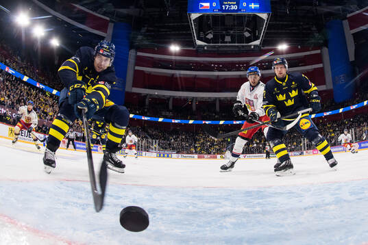 Henrik Tömmernes of Sweden stretches for the puck as Tim