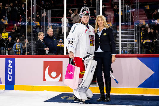 Goaltender Josef Korenar of Czech Republic is awarded