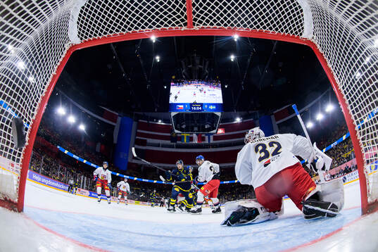 Sebastian Hartmann of Sweden scores 1-1 behind goaltender