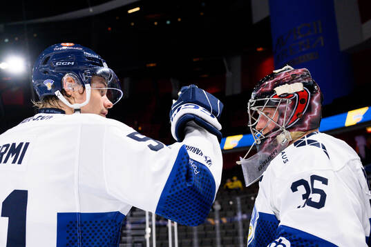 Markus Nurmi and goalkeeper Oskari Salminen of Finland