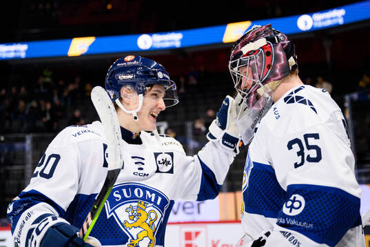 Oiva Keskinen and goalkeeper Oskari Salminen of Finland