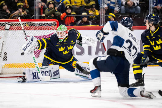 Eemil Erholtz of Finland scores the 0-1 goal behind