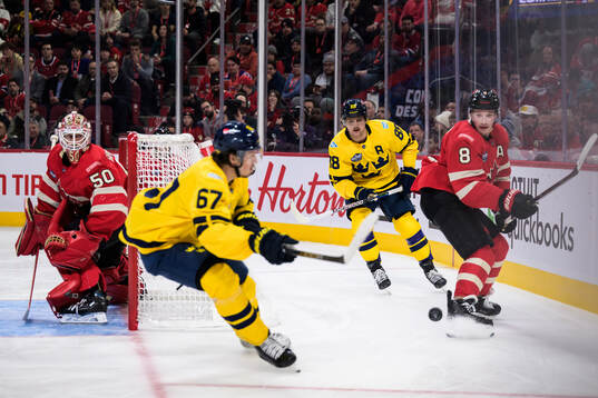 Goaltender Jordan Binnington and Cale Makar of Canada are