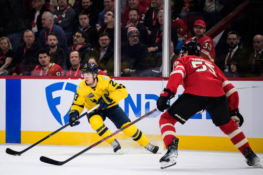 Lucas Raymond of Sweden and Colton Parayko of Canada