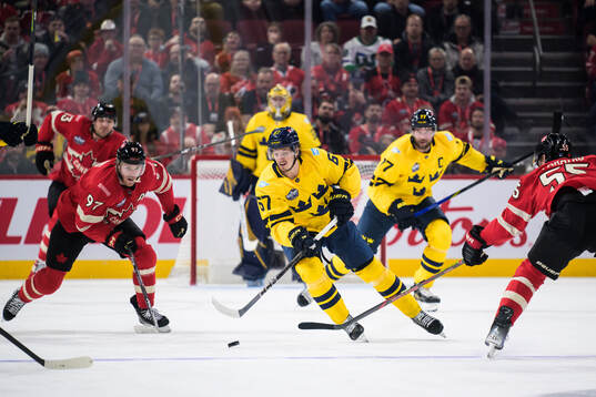 Connor McDavid and Colton Parayko of Canada are being