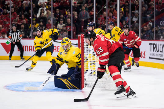 Goaltender Filip Gustavsson of Sweden is being challenged