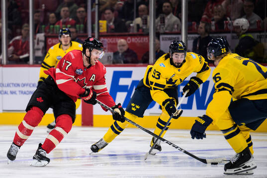 Connor McDavid of Canada challenges Mika Zibanejad of Sweden