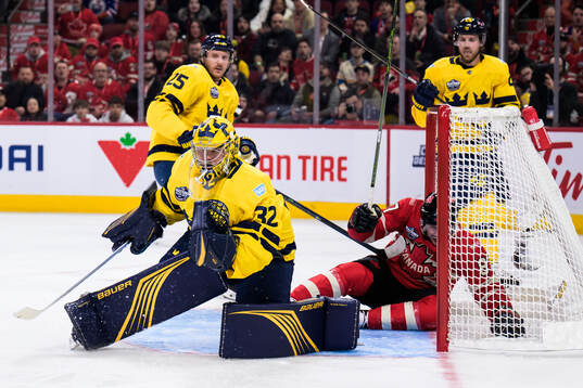 Goaltender Filip Gustavsson of Sweden and Sidney Crosby of