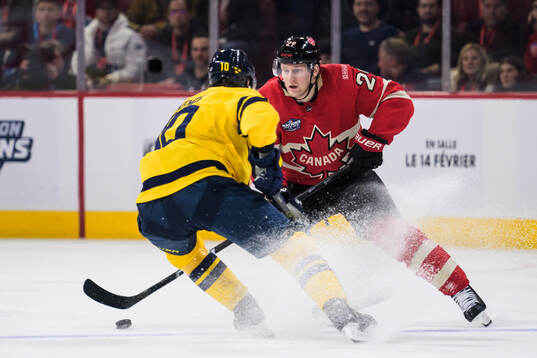 Adrian Kempe of Sweden and Nathan MacKinnon of Canada