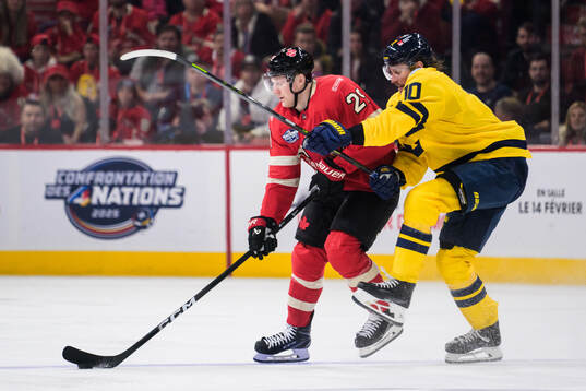 Nathan MacKinnon of Canada and Adrian Kempe of Sweden