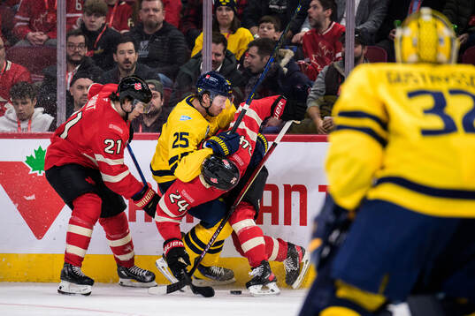 Brayden Point and Seth Jarvis of Canada in action against