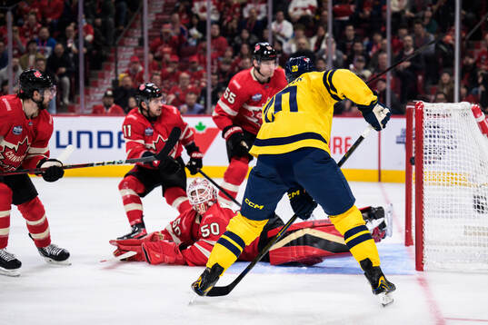 Joel Eriksson Ek of Sweden scores 3-3 behind goaltender