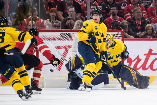 Devon Toews of Canada challenges Gustav Forsling and