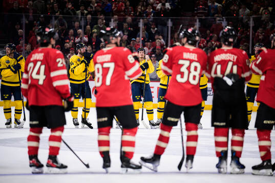 Mattias Ekholm and Rickard Rakell of Sweden look dejected