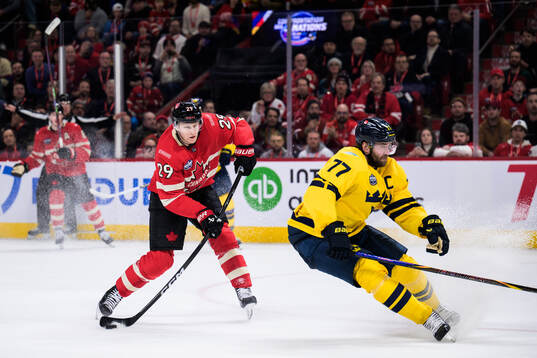 Nathan MacKinnon of Canada and Victor Hedman of Sweden