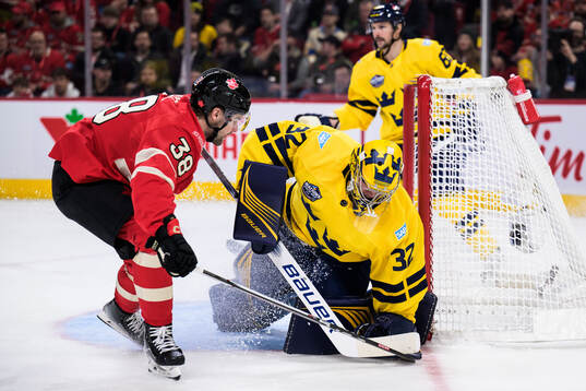 Brandon Hagel of Canada and goaltender Filip Gustavsson of