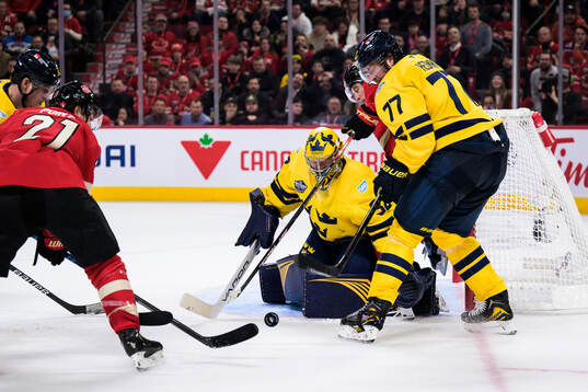 Goaltender Filip Gustavsson and Victor Hedman of Sweden