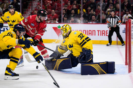 Josh Morrissey of Canada challenges Erik Karlsson and