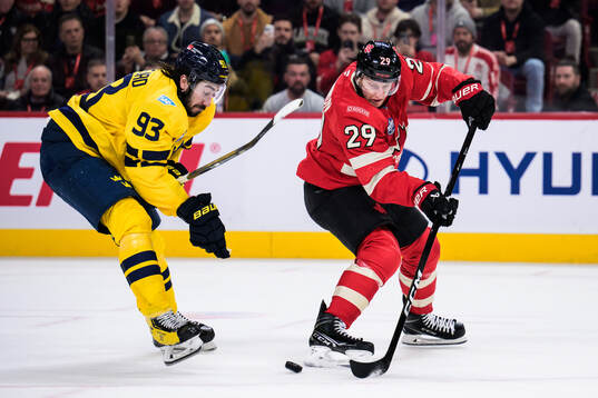 Mika Zibanejad of Sweden and Nathan MacKinnon of Canada