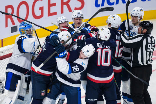 Brady Tkachuk of USA and Urho Vaakanainen of Finland