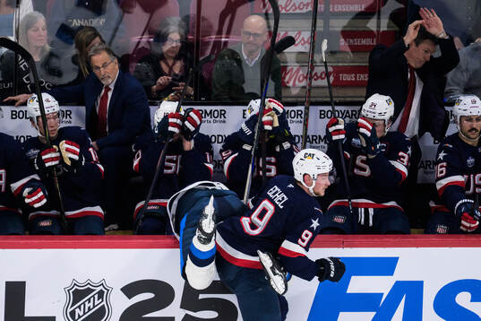 Jack Eichel of USA tackles Aleksander Barkov of Finland