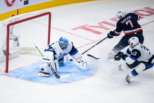 Brady Tkachuk of USA scores 5-1 behind goaltender Juuse