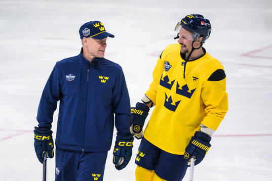 Assistant coach Nicklas Rahm and Erik Karlsson of Sweden at