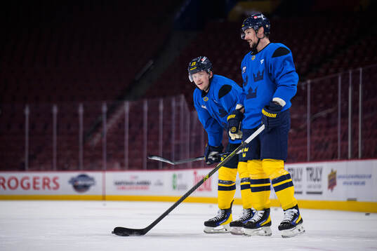 Lucas Raymond and Erik Karlsson of Sweden at a practice
