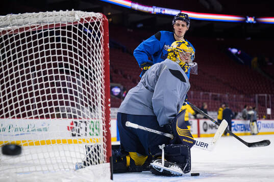 Goaltender Filip Gustavsson and Joel Eriksson Ek of Sweden