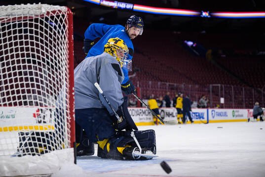 Goaltender Filip Gustavsson and Filip Forsberg of Sweden at