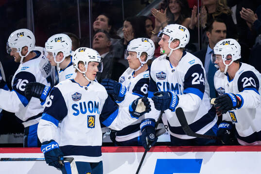 Anton Lundell of Finland celebrates with teammates