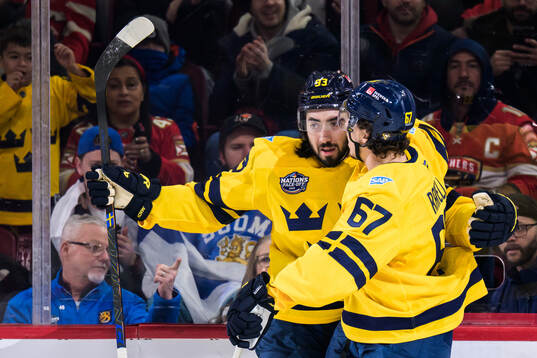 25021 Mika Zibanejad and Rickard Rakell of Sweden celebrate