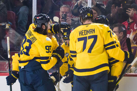 Erik Karlsson of Sweden celebrates with teammates