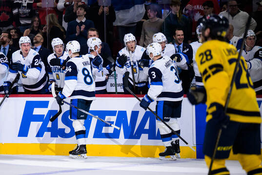Kaapo Kakko and Olli Määttä of Finland celebrate the 3-3