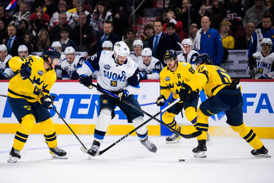 Jonas Brodin and Rickard Rakell of Sweden are being