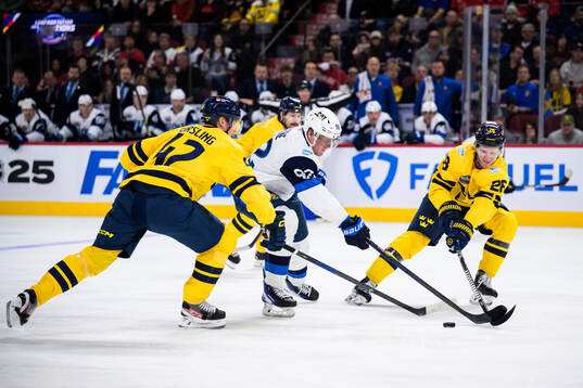 Patrik Laine of Finland challenges Gustav Forsling and