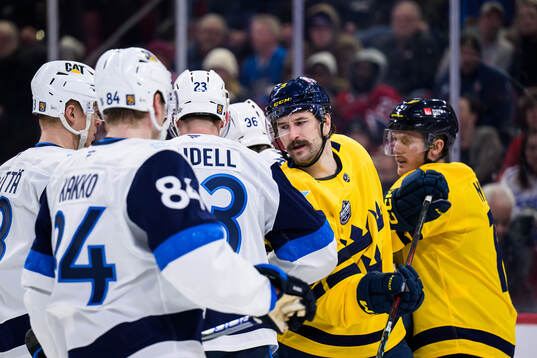 Esa Lindell of Finland and Filip Forsberg of Sweden