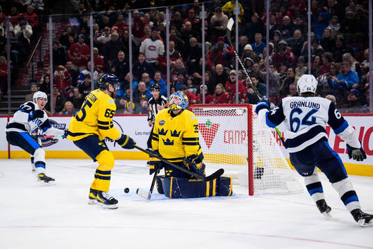 Niko Mikkola and Mikael Granlund of Finland celebrate the