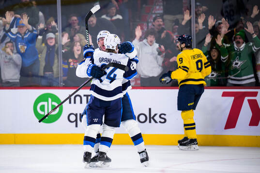 Mikko Rantanen and Mikael Granlund of Finland celebrate the