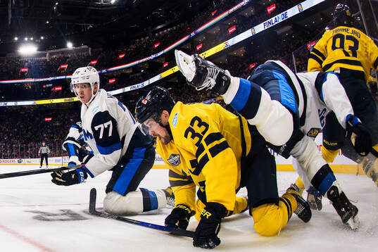 Niko Mikkola and Aleksander Barkov of Finland in action