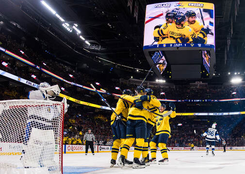 Rasmus Dahlin of Sweden celebrates with teammates
