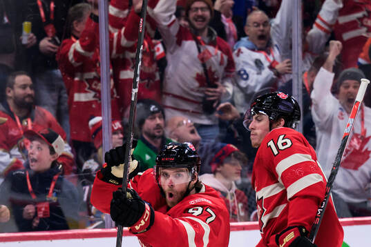 Connor McDavid and Mitch Marner of Canada celebrate the 1-0