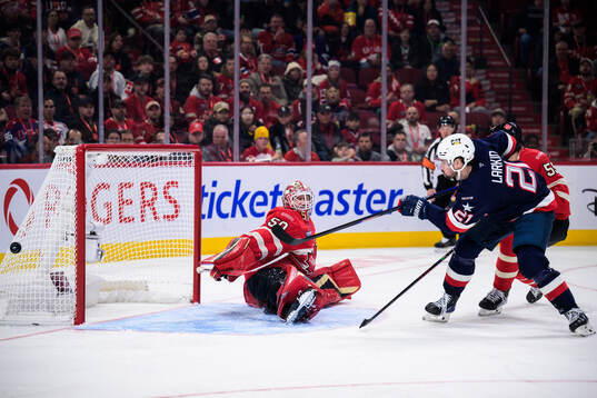 Dylan Larkin of USA shoots against goaltender Jordan