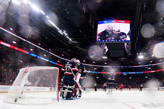 Goaltender Connor Hellebuyck and Charlie McAvoy of USA