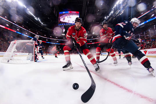 Brandon Hagel and Mark Stone of Canada in action against