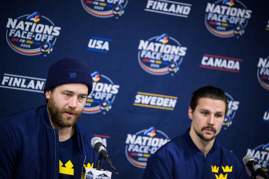 Victor Hedman and Erik Karlsson of Sweden are being